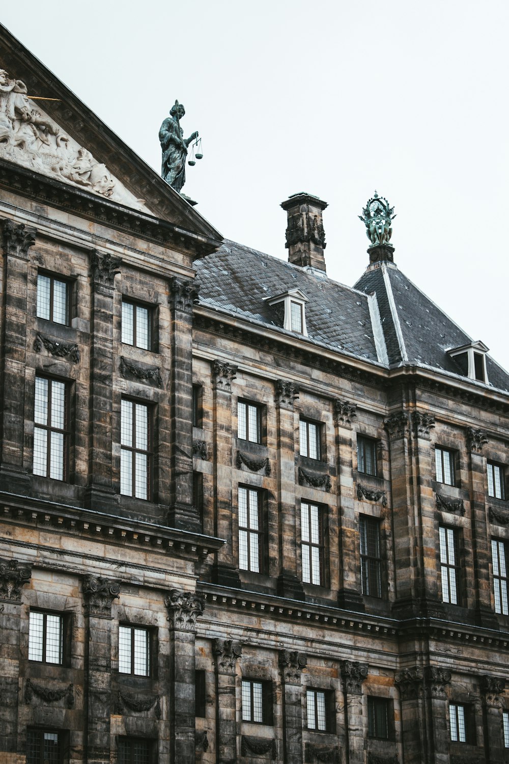 a large building with statues on top of it