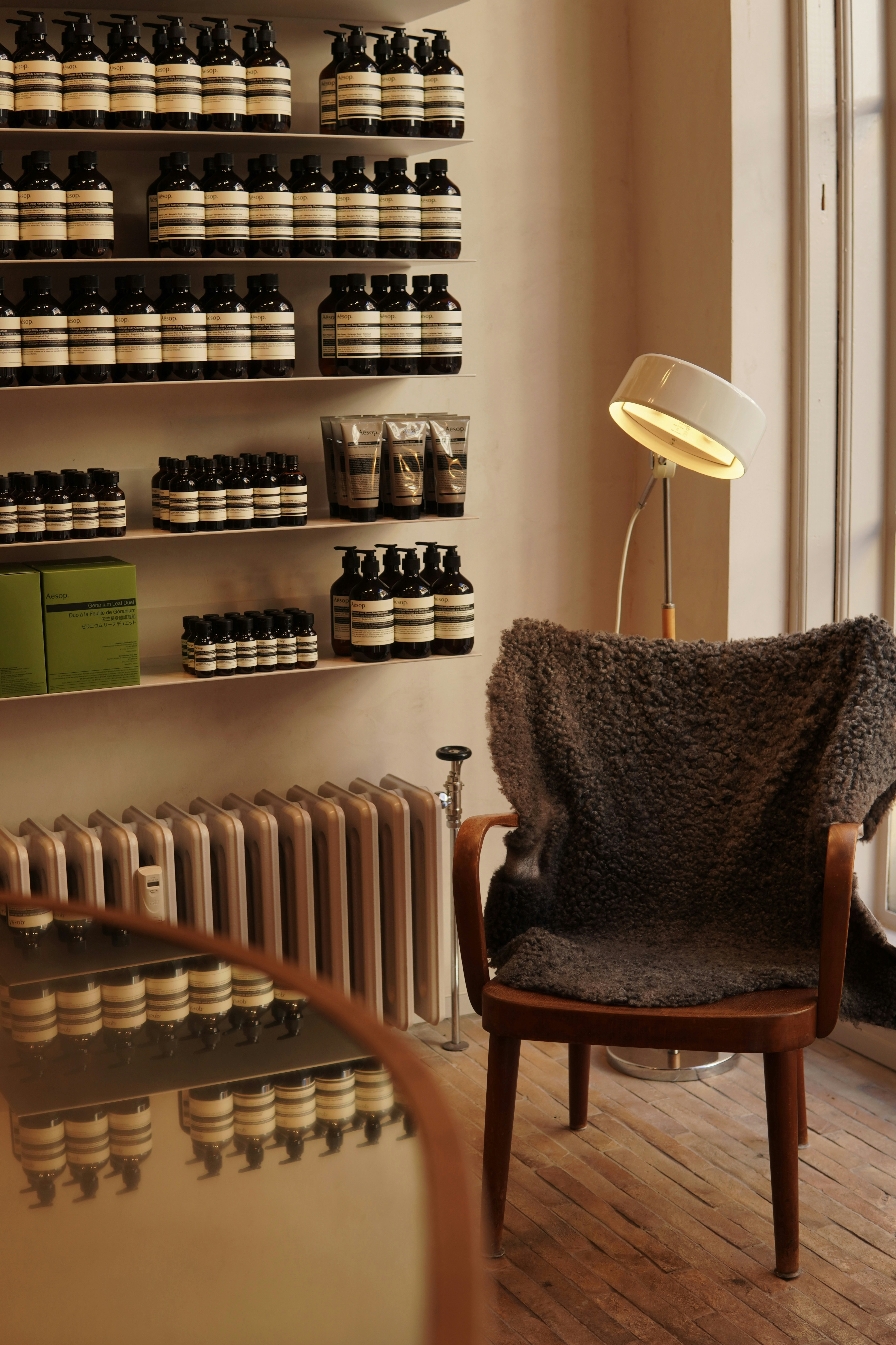 a chair sitting in front of a wall filled with bottles