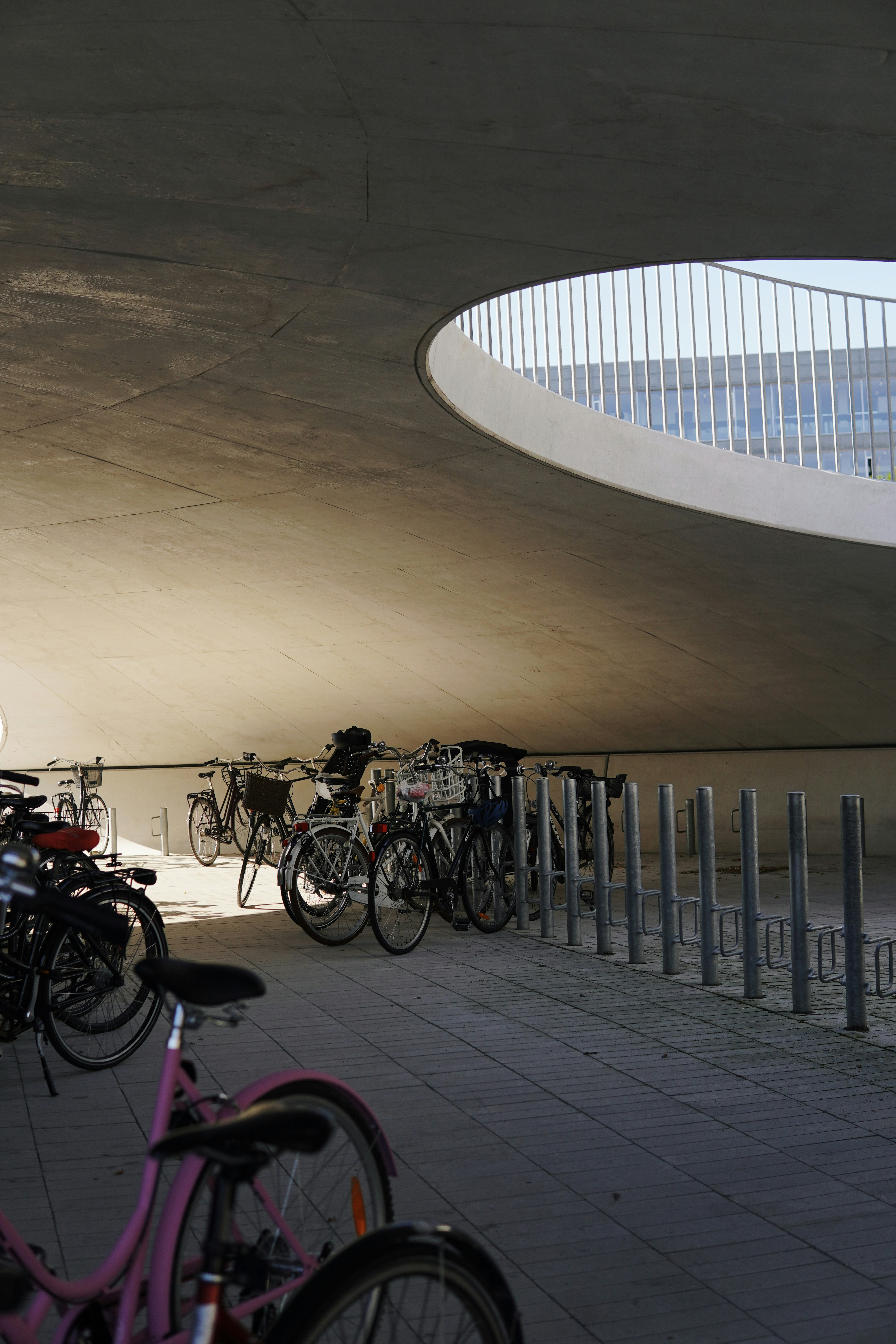a group of bikes parked next to each other under a bridge