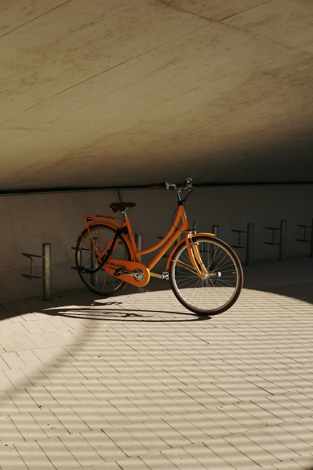 an orange bike parked in a parking garage