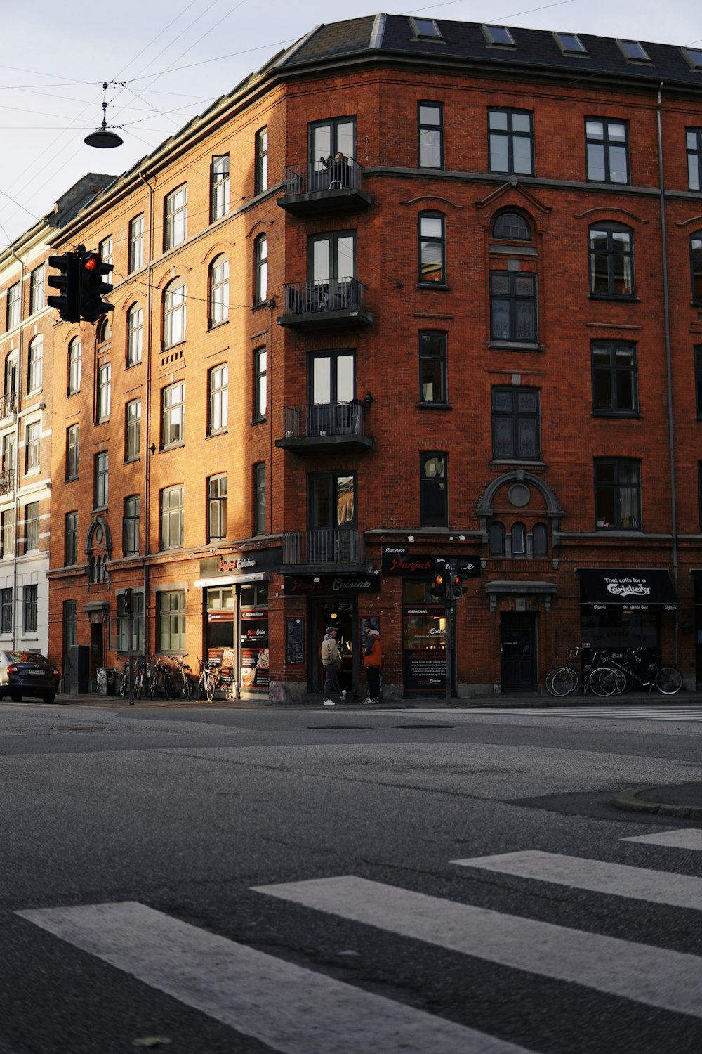 a large red brick building sitting on the corner of a street