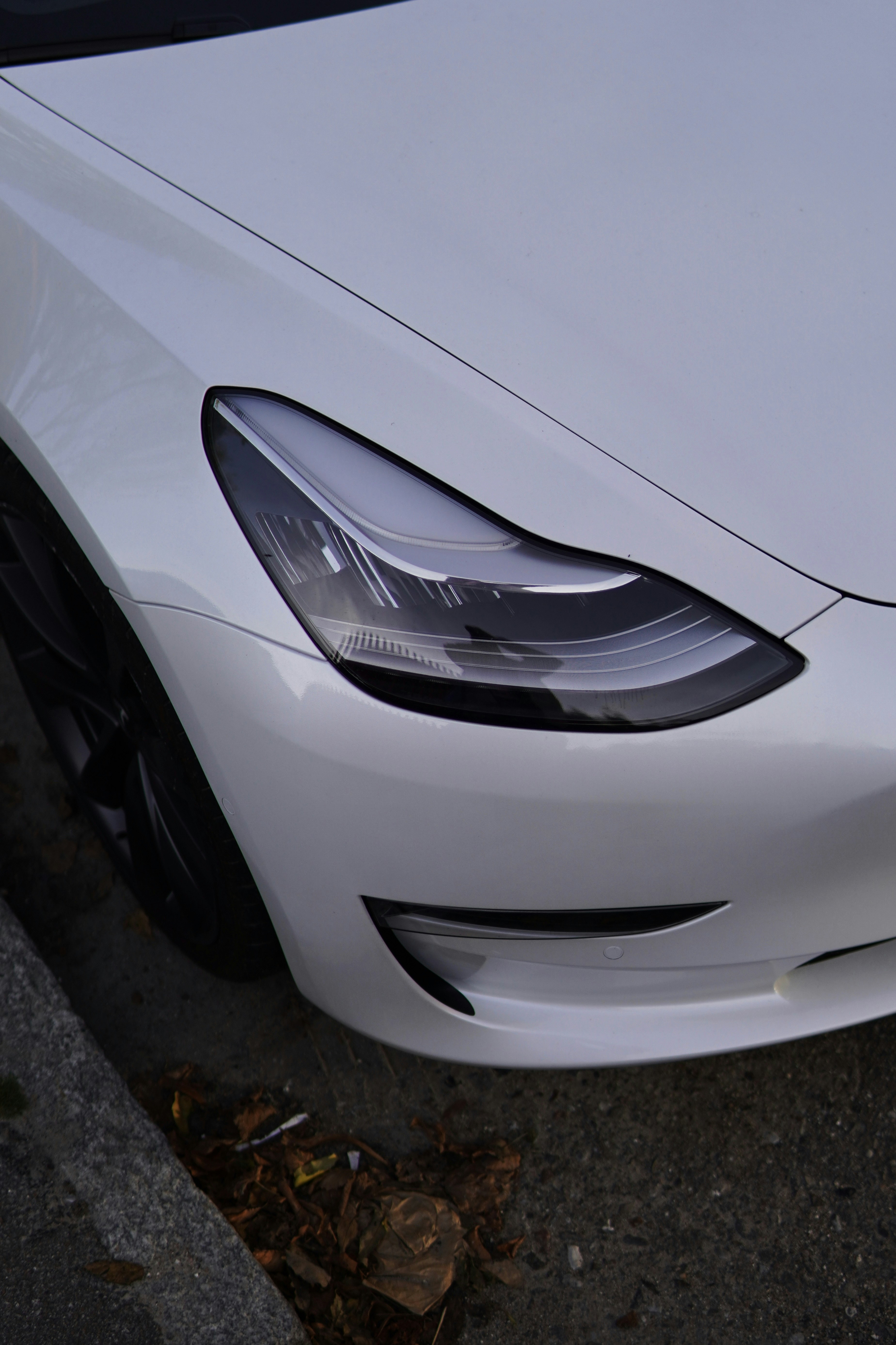 a white car parked on the side of the road