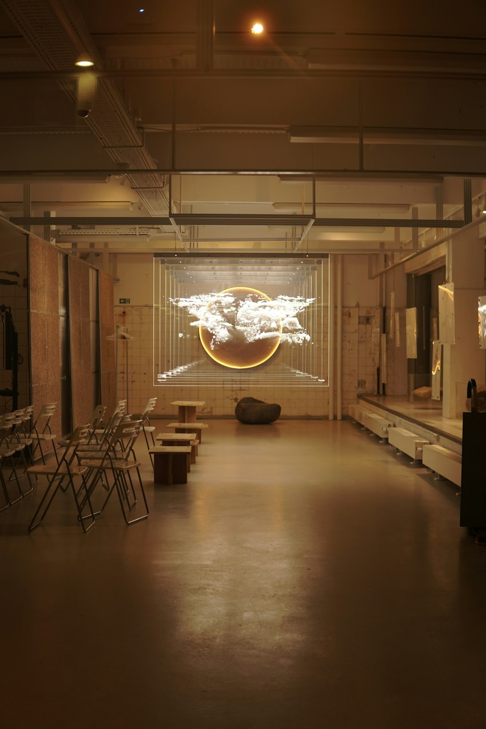 a dimly lit room with chairs and tables