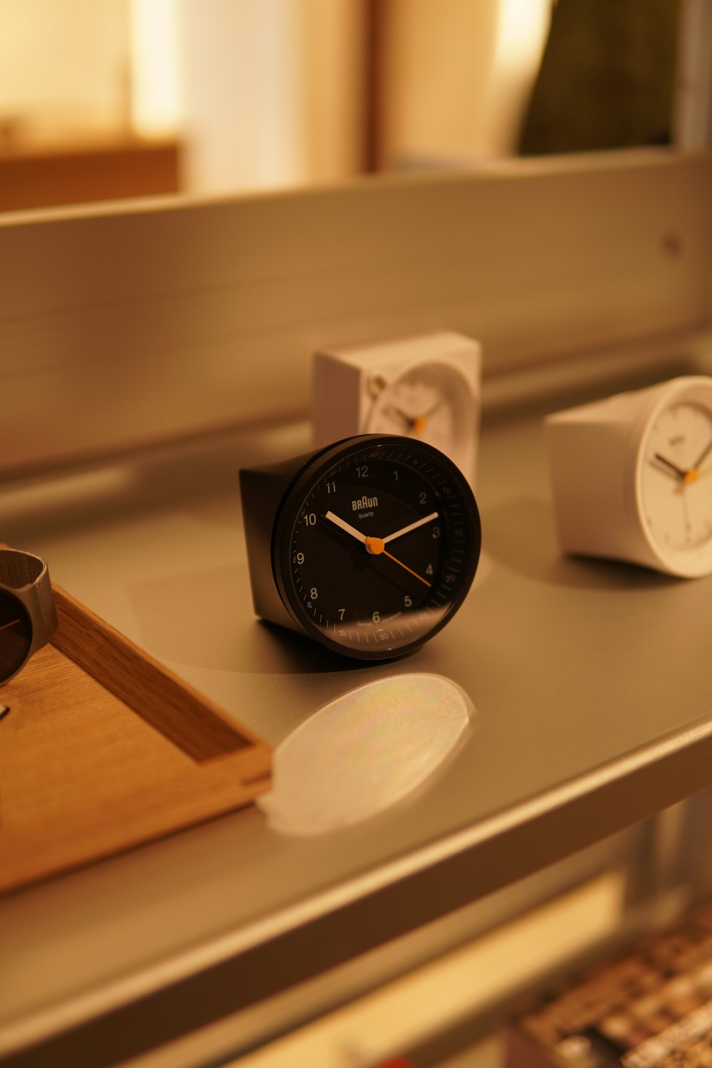 a couple of clocks sitting on top of a table