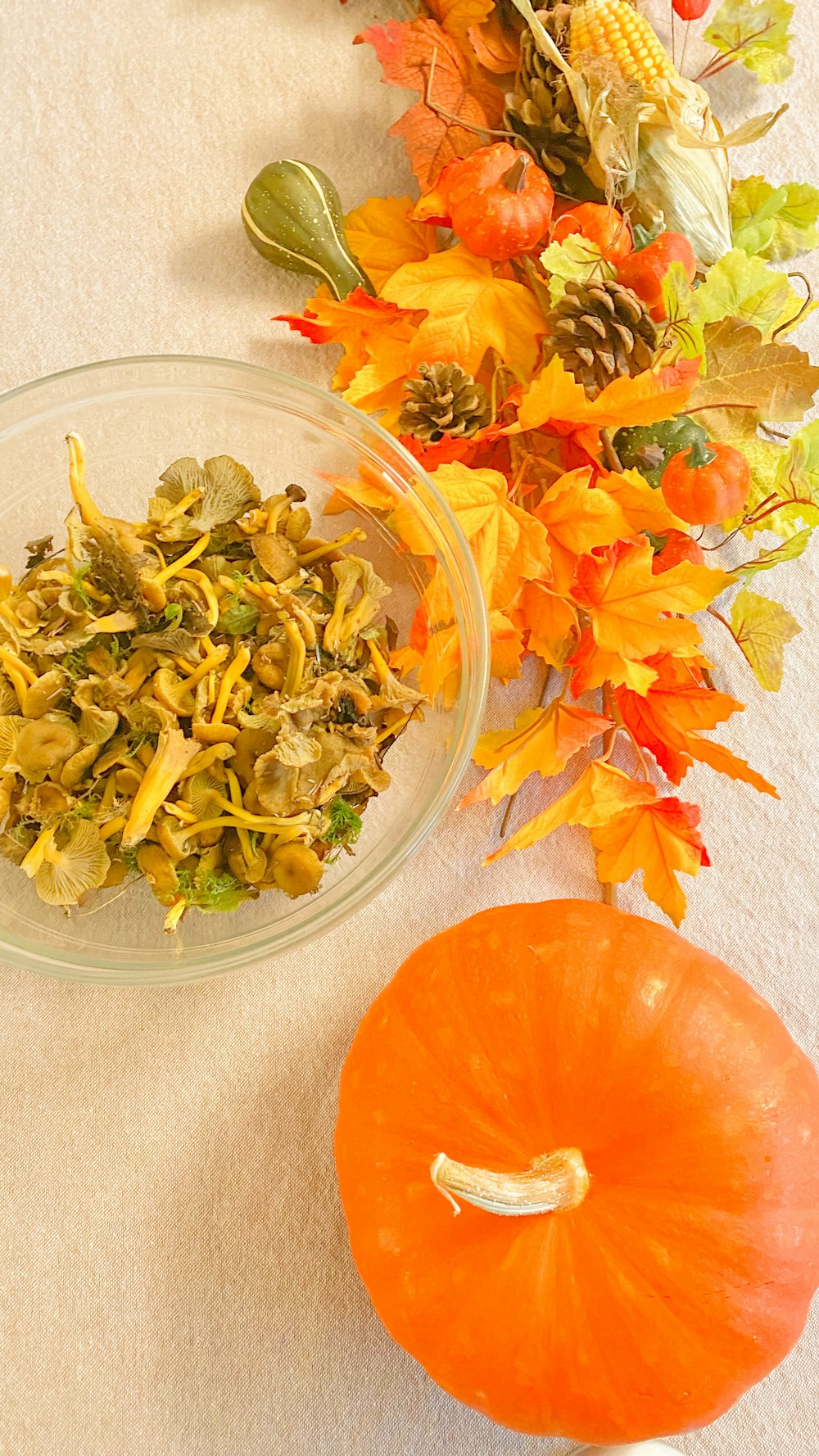 a table with a bowl of food and a pumpkin