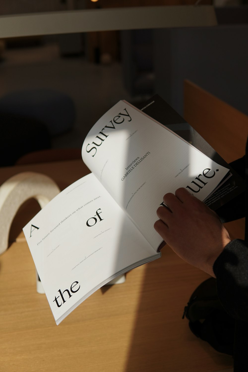 a person reading a book with the word survey on it