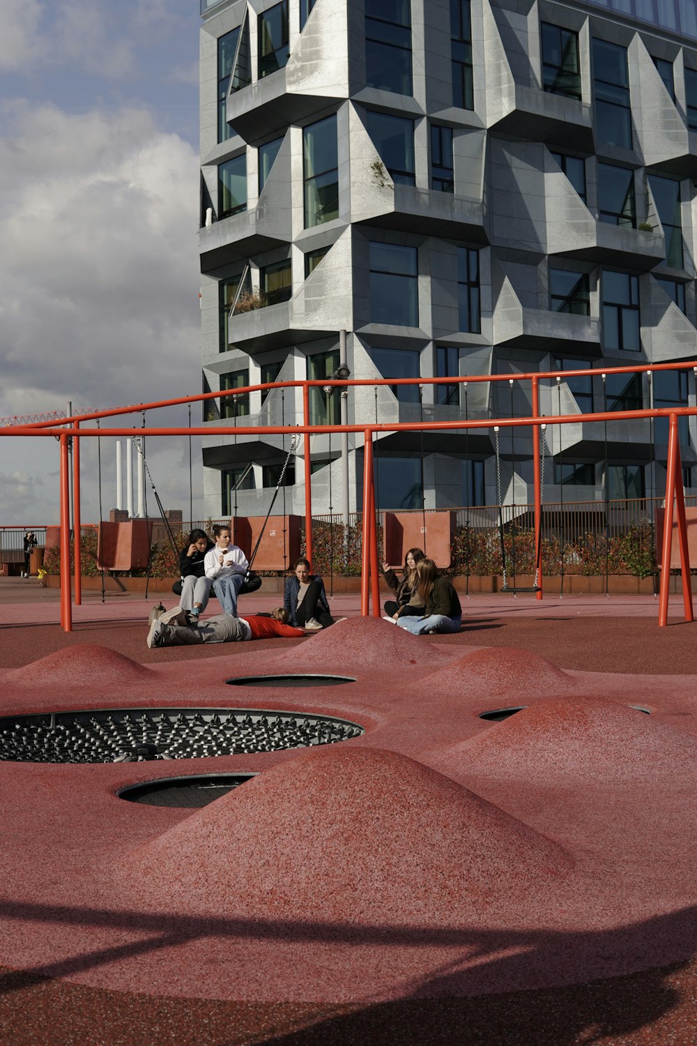 a group of people sitting on top of a playground