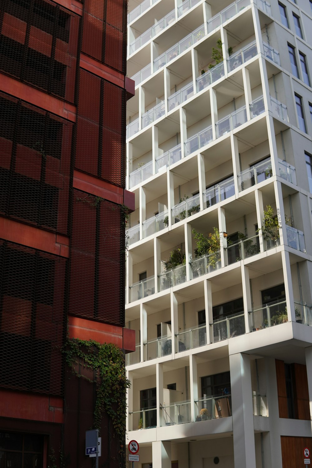 a tall white building next to a tall red building