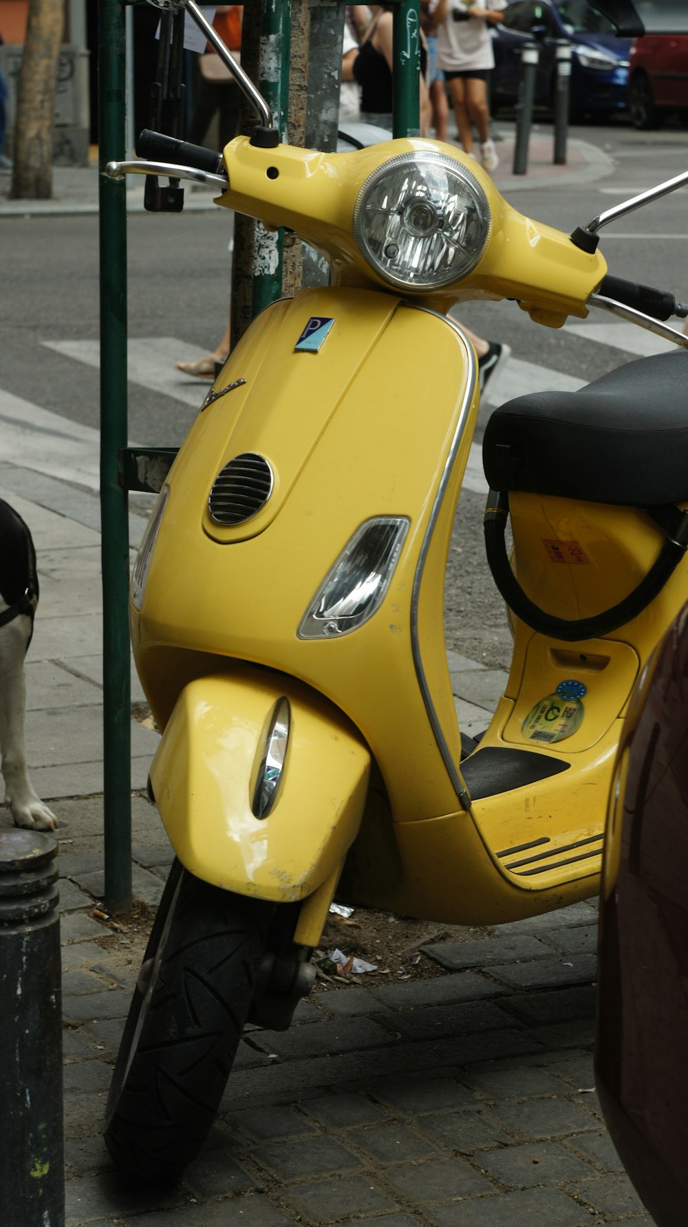 a yellow scooter parked on the side of the road
