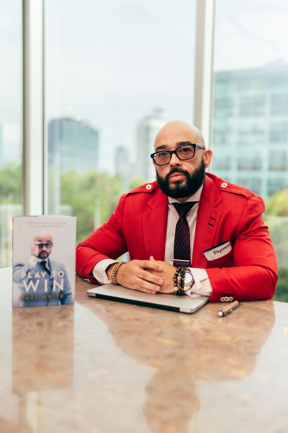 a man sitting at a table in front of a book