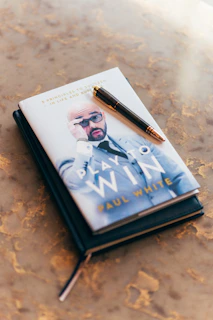 a book with a pen on top of it