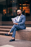 a man sitting on steps reading a book