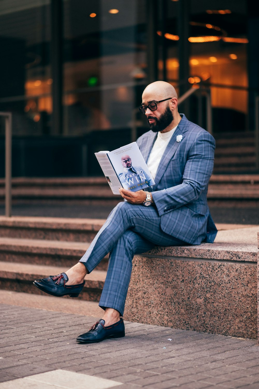 a man sitting on steps reading a book