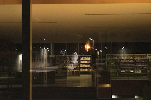 Quiet and cozy Japanese minimalist school library interior with warm lighting