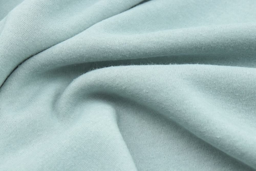 a close up view of a light blue fabric