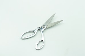 a pair of scissors sitting on top of a table