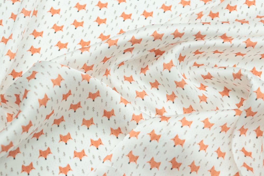an orange and white fabric with stars on it