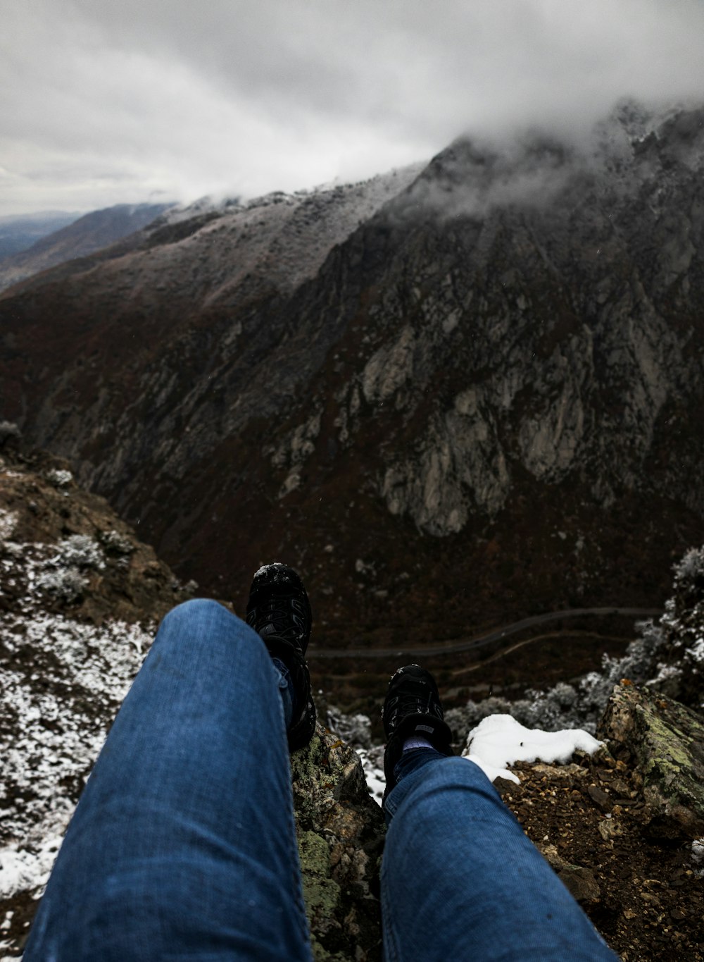 a person sitting on top of a snow covered mountain