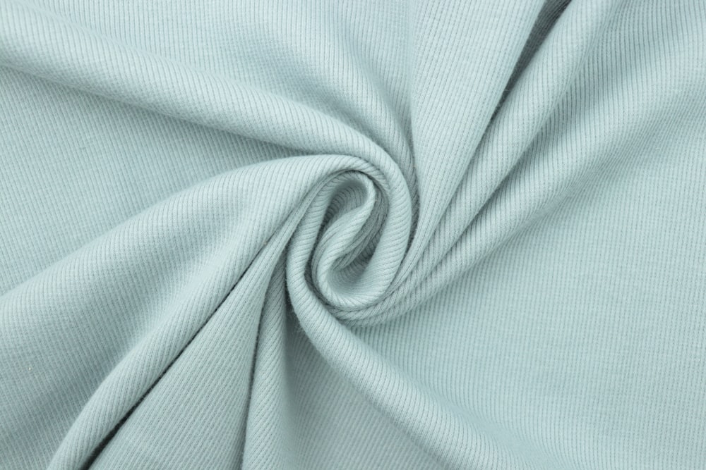 a close up shot of a light blue fabric
