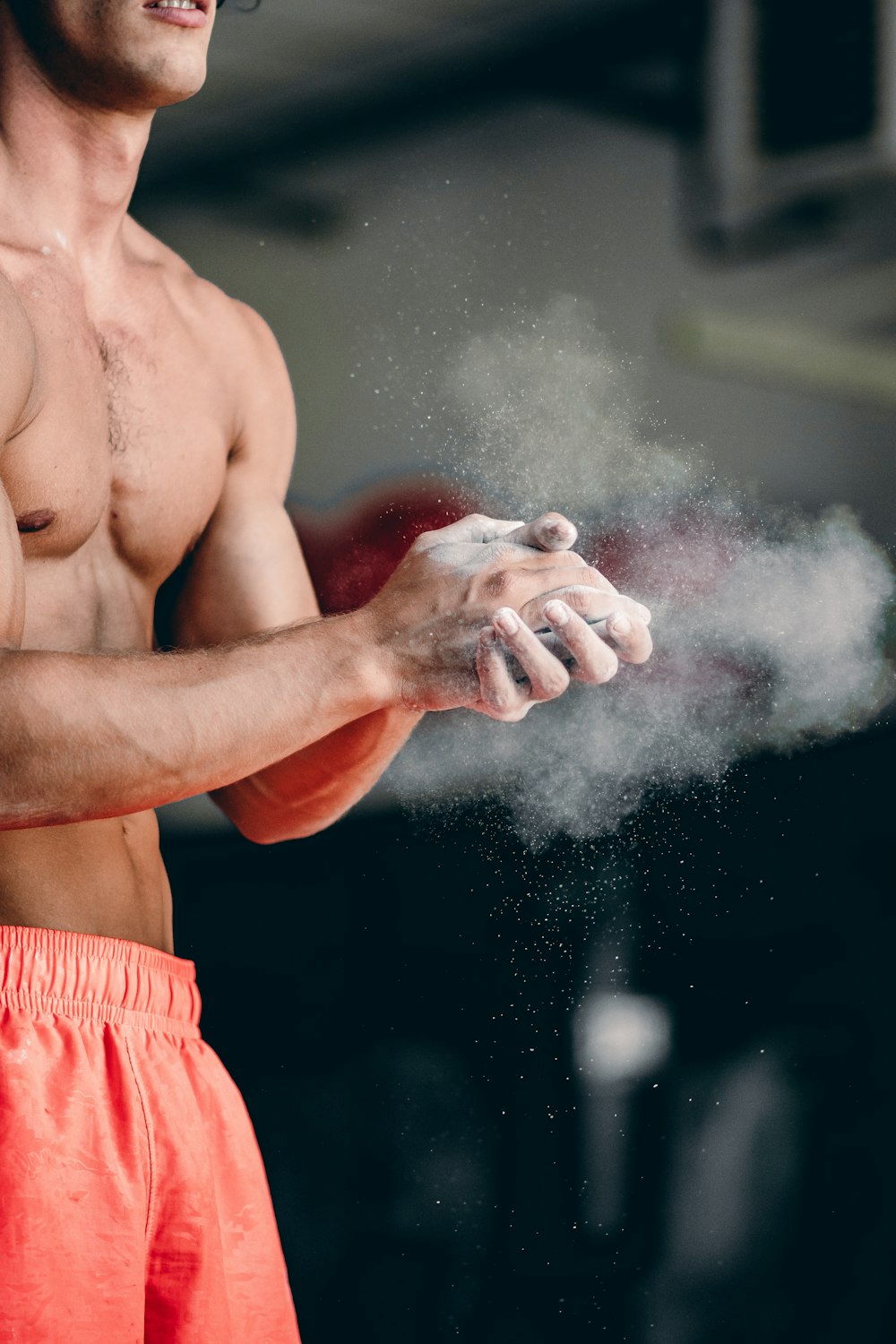 a shirtless man holding a white object in his hand