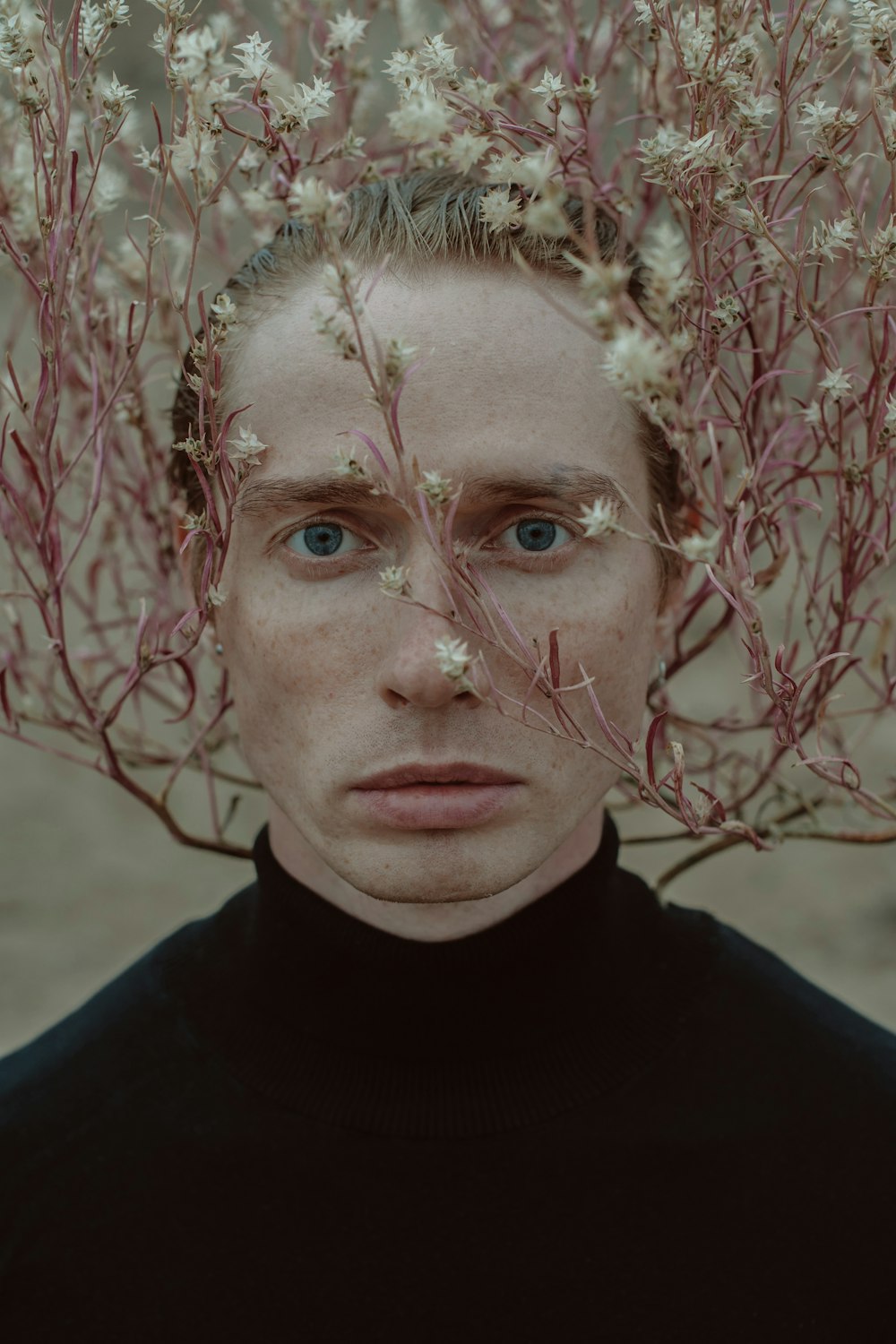 a man with flowers on his head