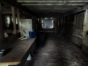 The first community meeting of the co-operative held in a cozy farmstead barn with hand-drawn plans on the walls