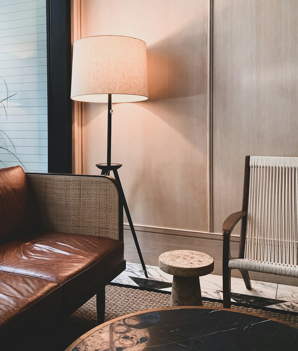 a living room with a couch, chair and lamp