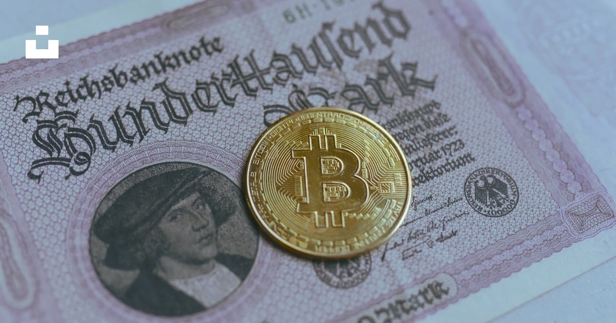 A bitcoin sitting on top of a bank note photo – Free Bitcoin gold Image ...