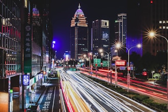 A dynamic cityscape at night showcasing bright lights and energy.
