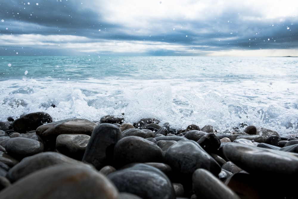 a bunch of rocks sitting on top of a beach