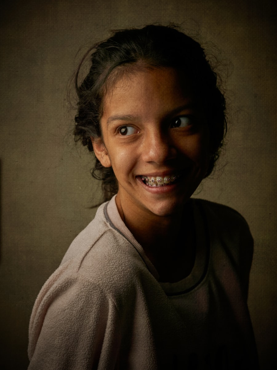 Young patient smiling with traditional braces on her teeth