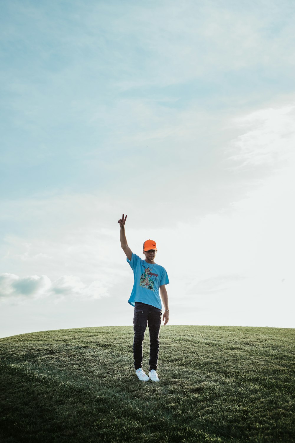 a man standing on top of a lush green field