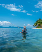 a man in the water with a fishing pole