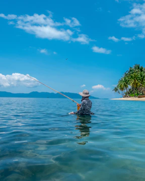 a man in the water with a fishing pole