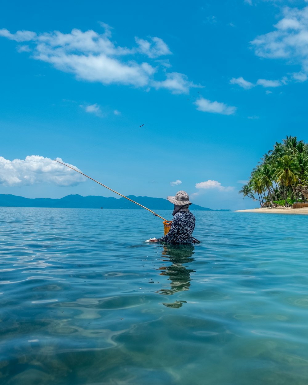 a man in the water with a fishing pole