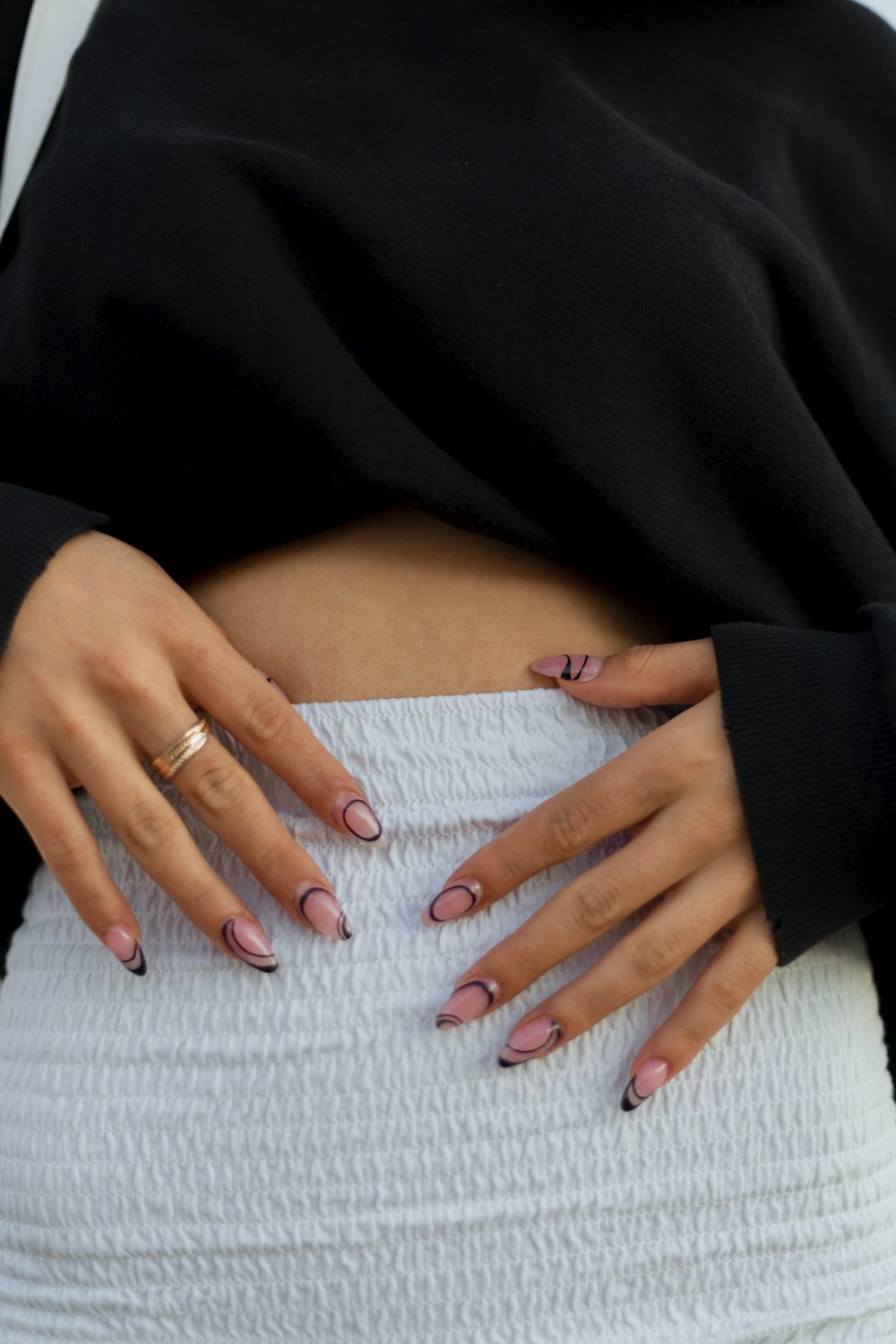 a woman's stomach with her hands on her hips