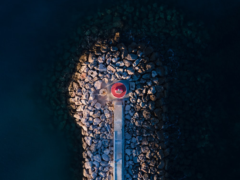 an aerial view of a street light surrounded by rocks