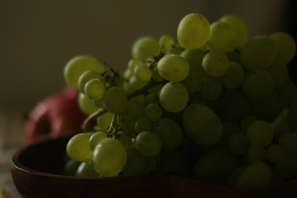 a close up of a bowl of grapes