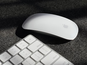 a computer mouse and keyboard on a black surface