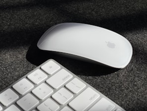 a computer mouse and keyboard on a black surface