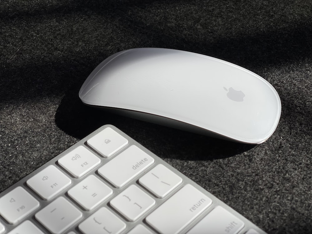 a computer mouse and keyboard on a black surface