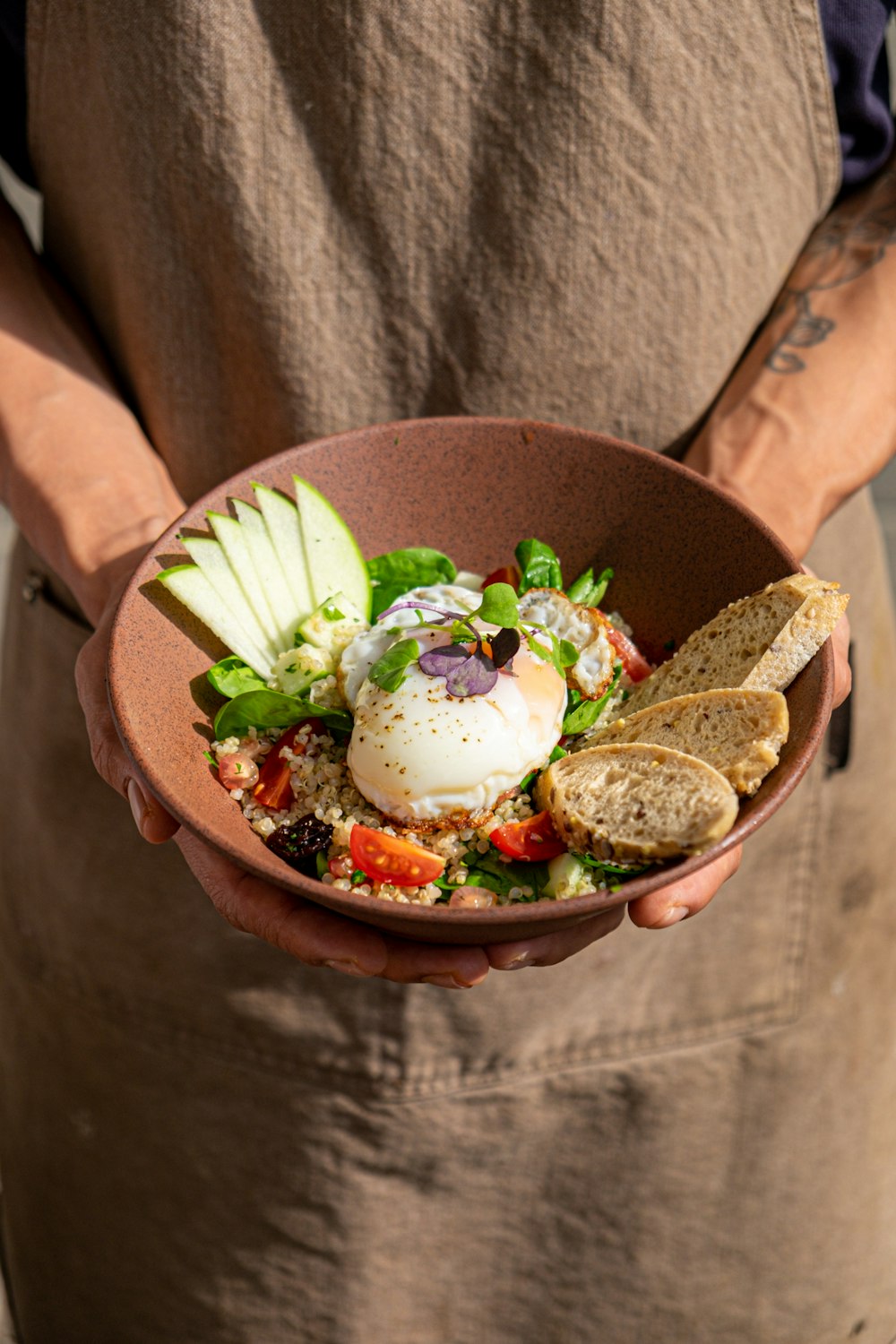 a person holding a bowl of food in their hands