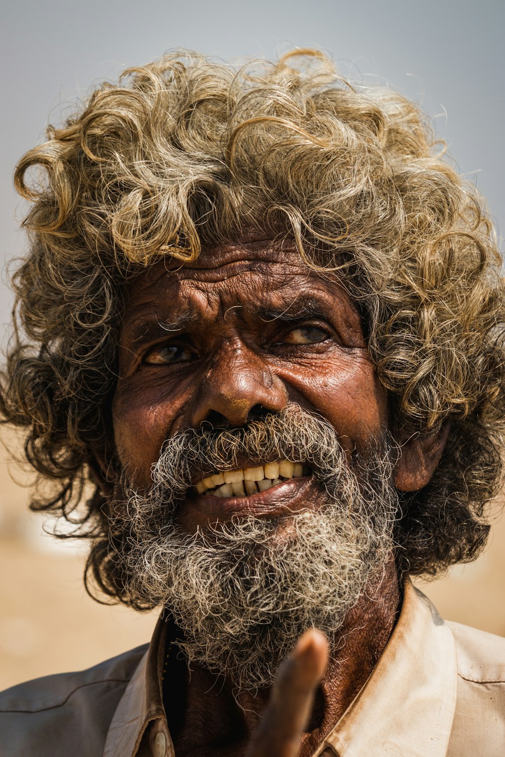 a man with curly hair and a beard