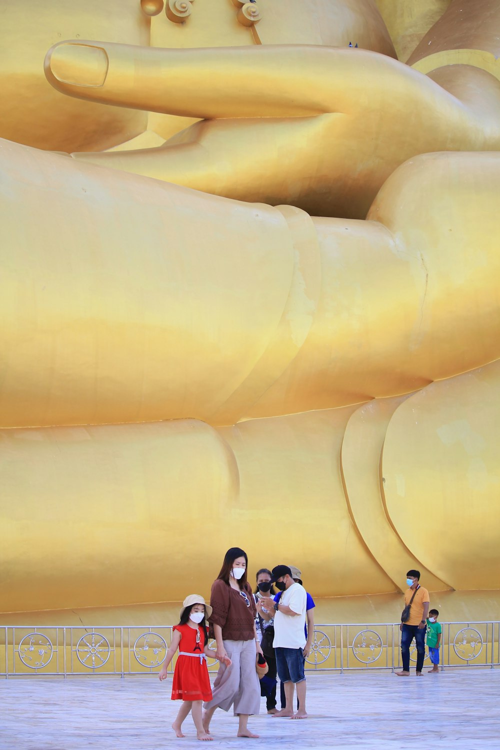 a group of people standing in front of a giant statue