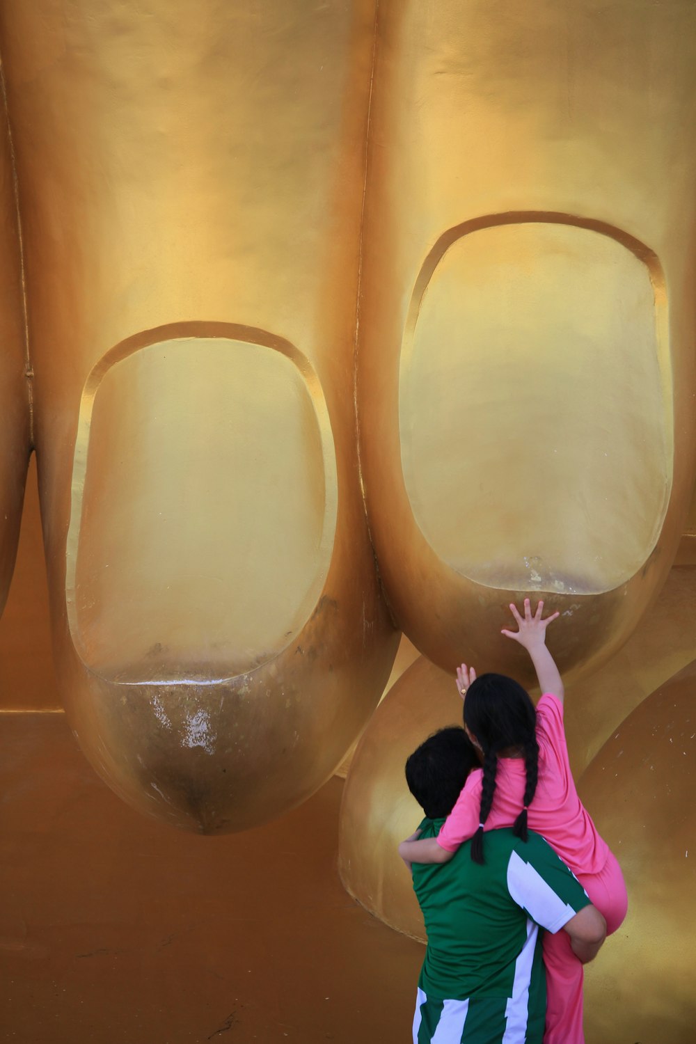 a couple of people that are standing in front of a sculpture