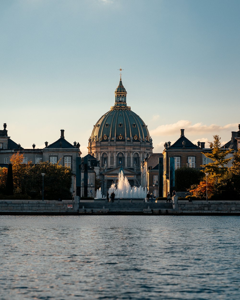 a large building with a fountain in front of it