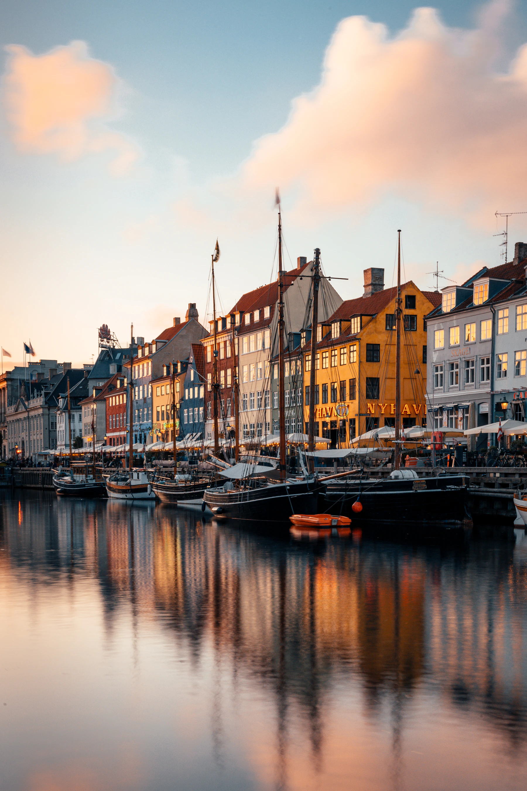 Boats line the Nyhavn canal beside historic waterfront buildings.