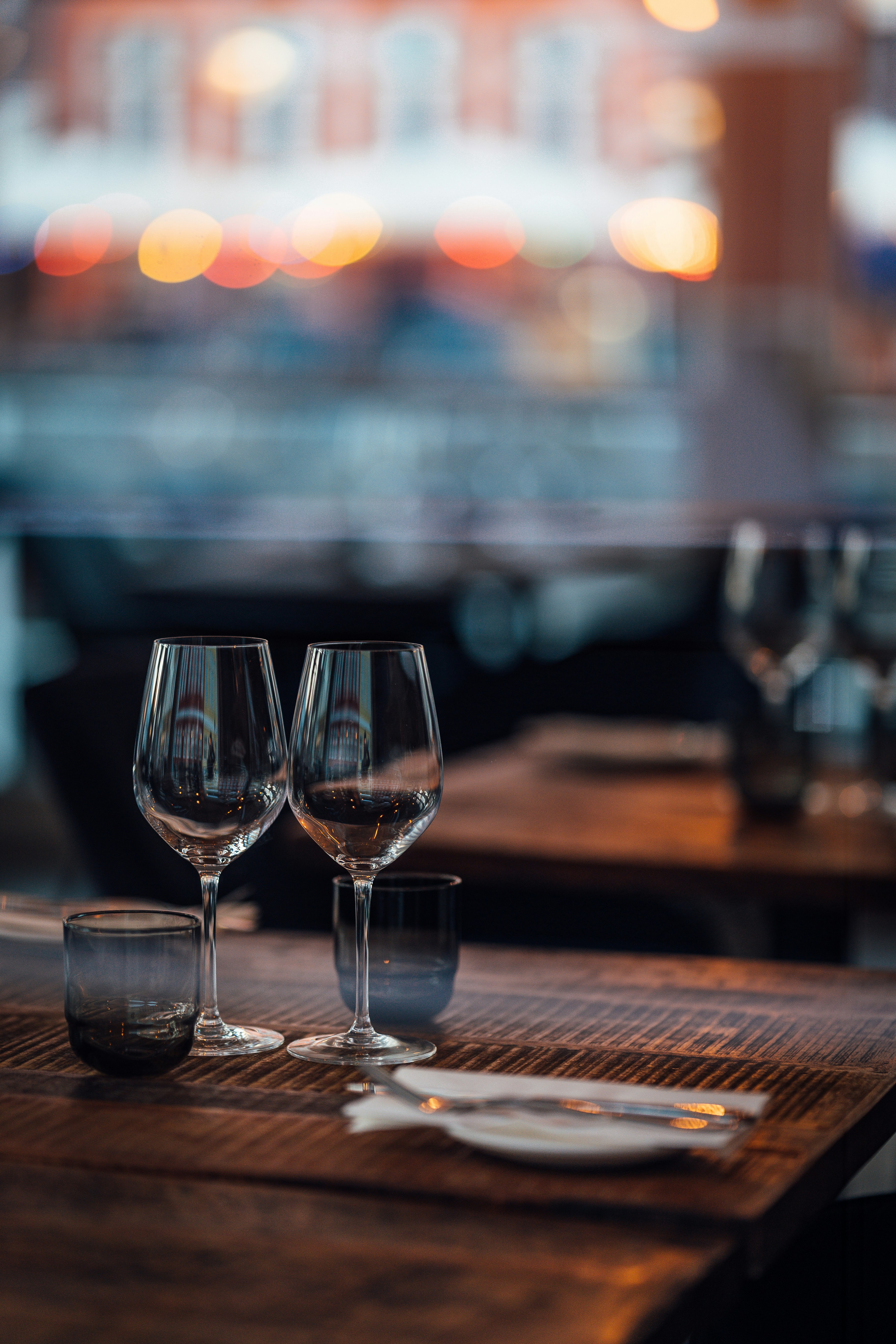 two wine glasses sitting on top of a wooden table
