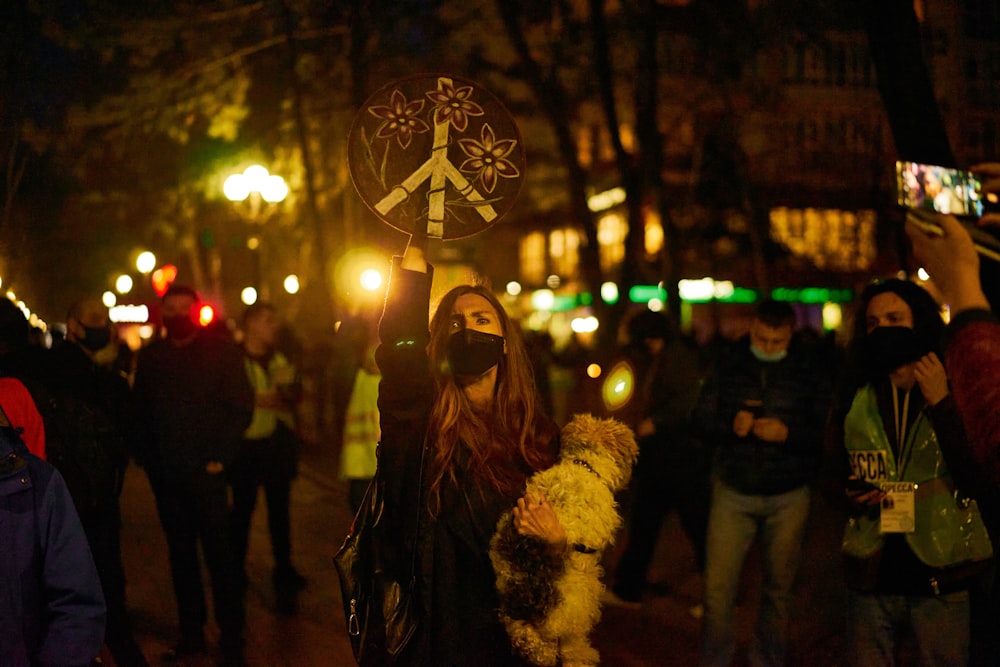 a group of people standing on a street at night