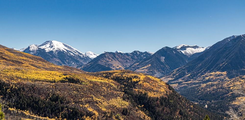 a view of a mountain range with snow capped mountains in the background